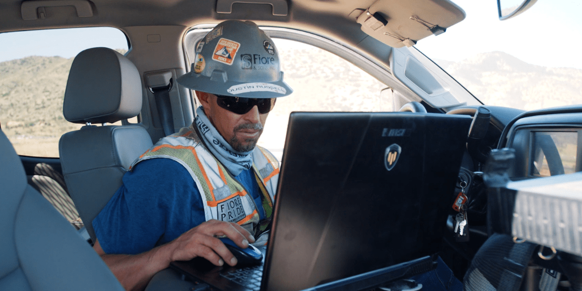 Justin from Fiore on laptop in truck