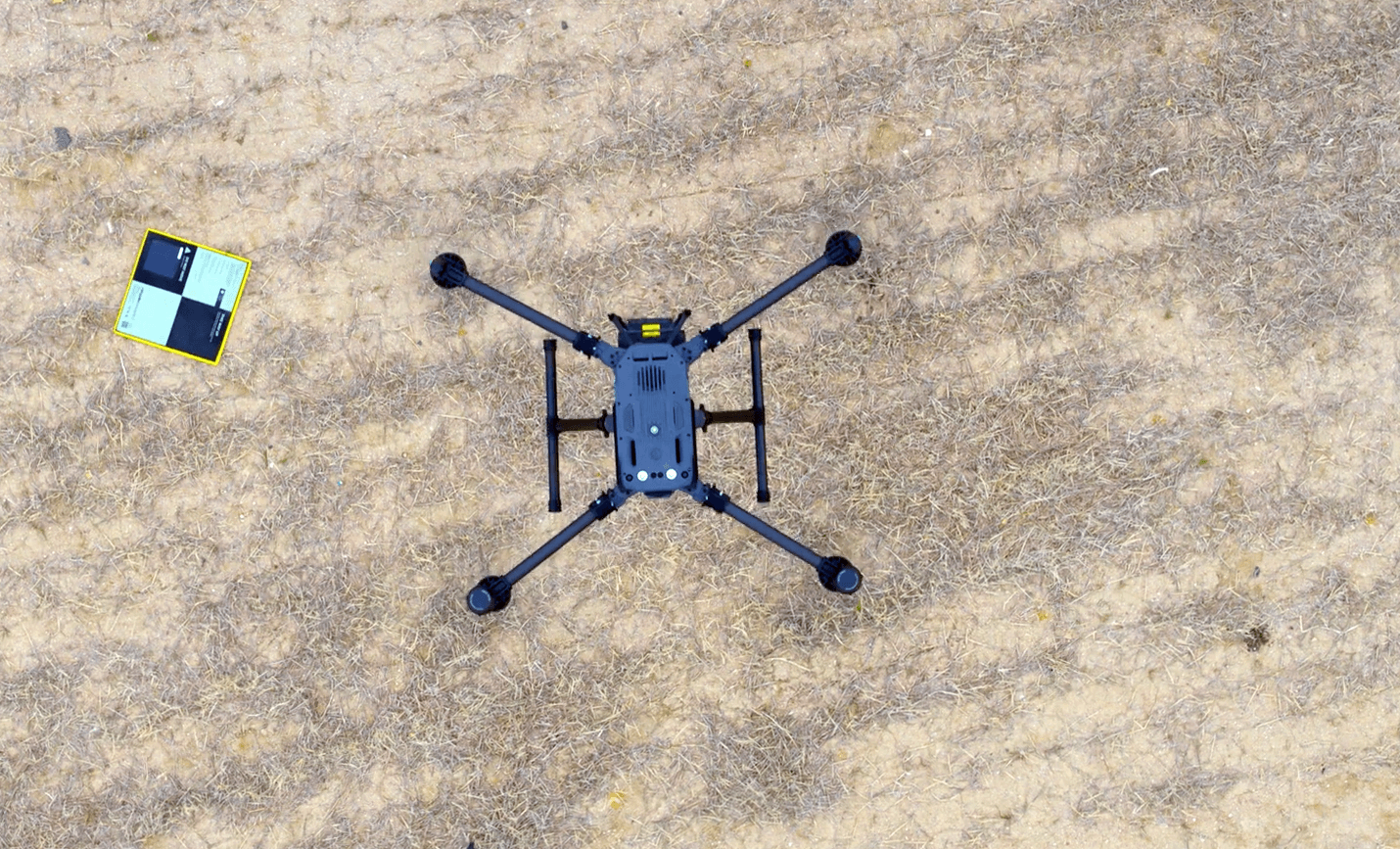 Photo looking down at the top of a drone next to an AeroPoint.