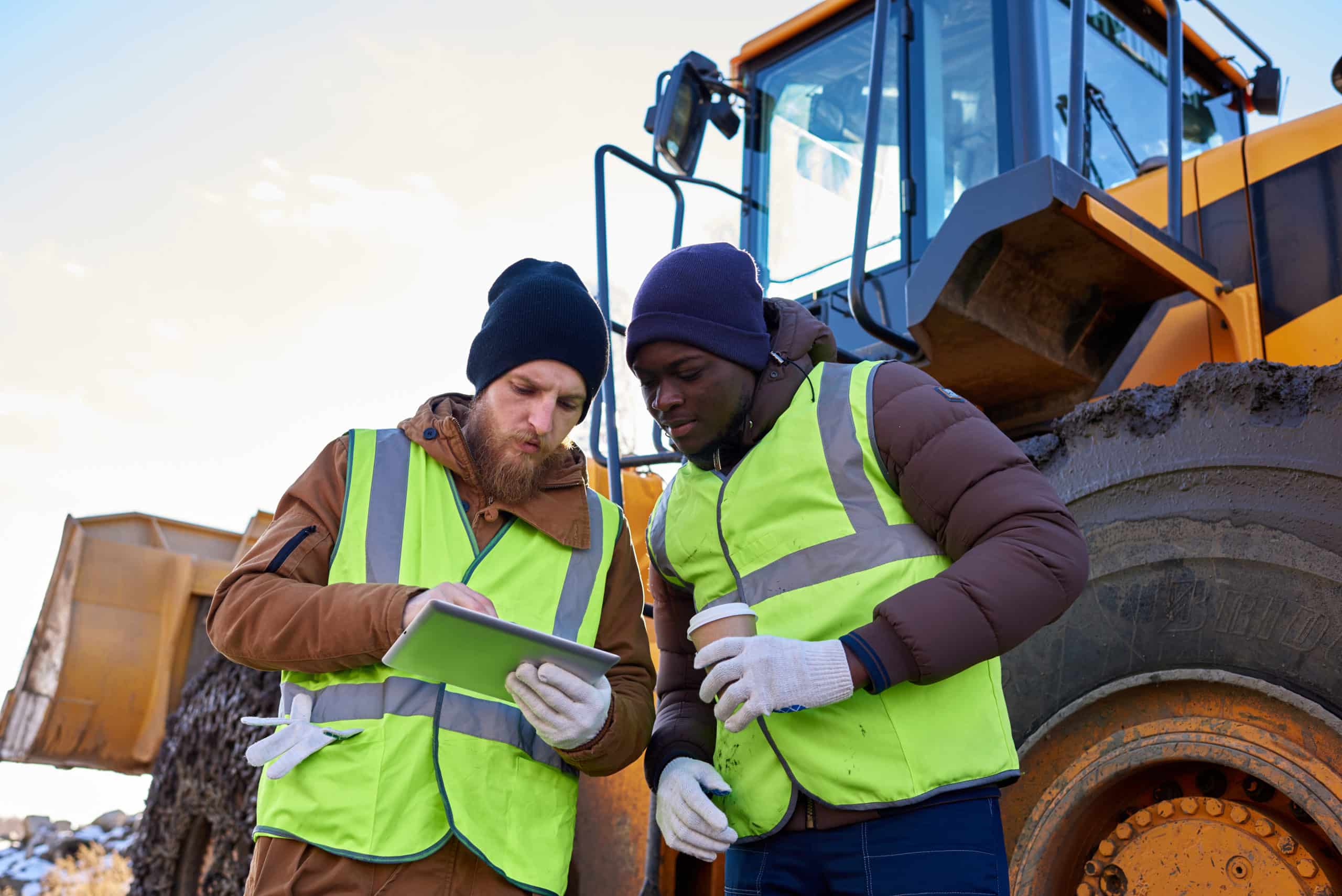 Two people looking at Propeller mobile app on job site