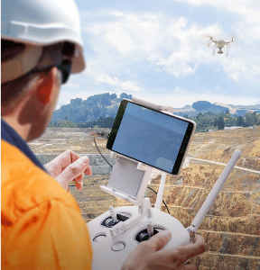 A drone pilot holding the controller.