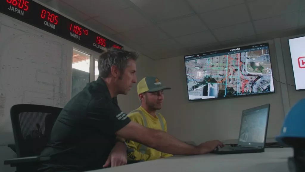 Hensel Phelps Honolulu Airport employees looking at a laptop