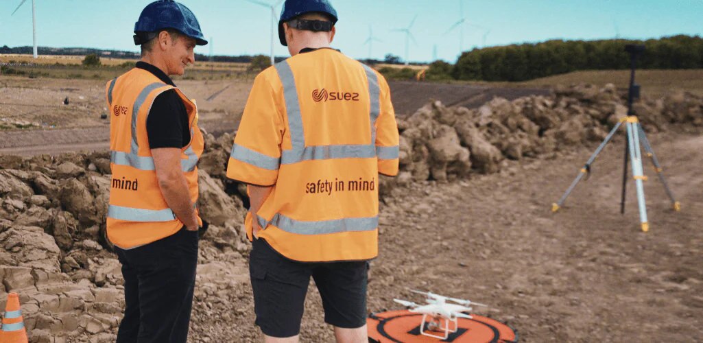 two men from the suez team preparing for a drone flight