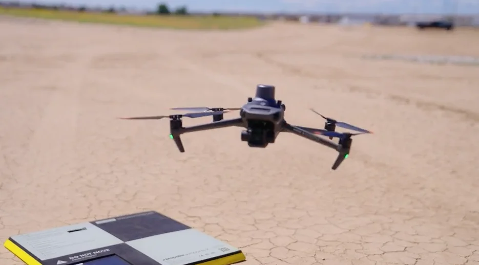 A drone hovering above an AerPoint sat on the ground.