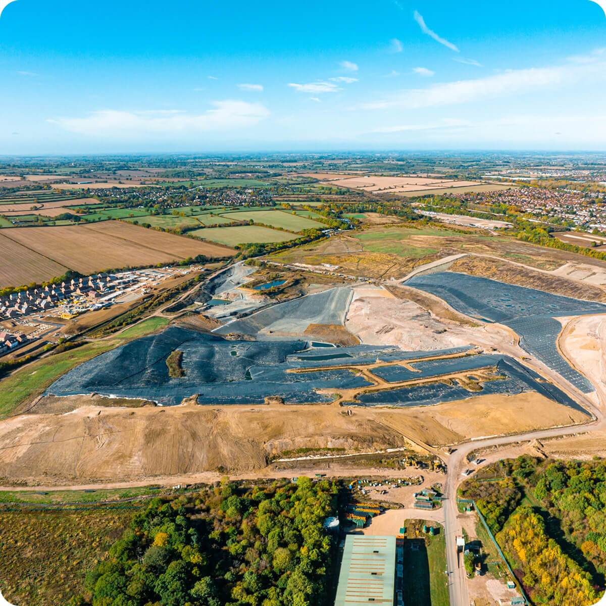 waste management garbage truck dumping into a landfill