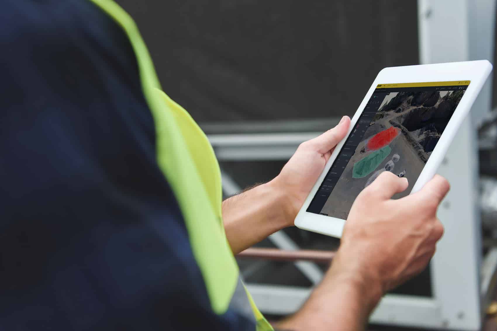 Over-the-shoulder photo of someone looking at the Propeller platform on a tablet.