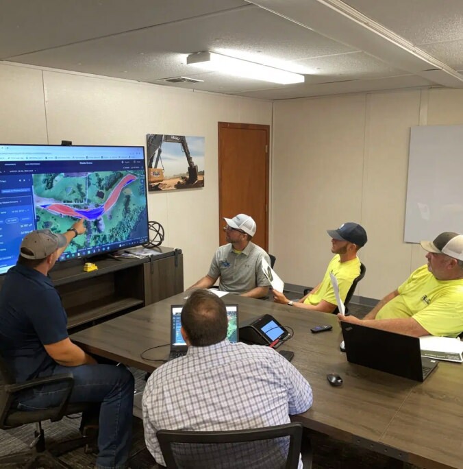 Matt Eklund and his team reviewing propeller on a conference room TV