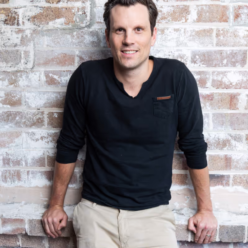 Person standing in front of brick wall
