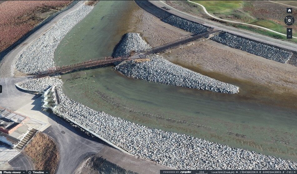 Aerial photo of a canal section showing a bridge in the background.