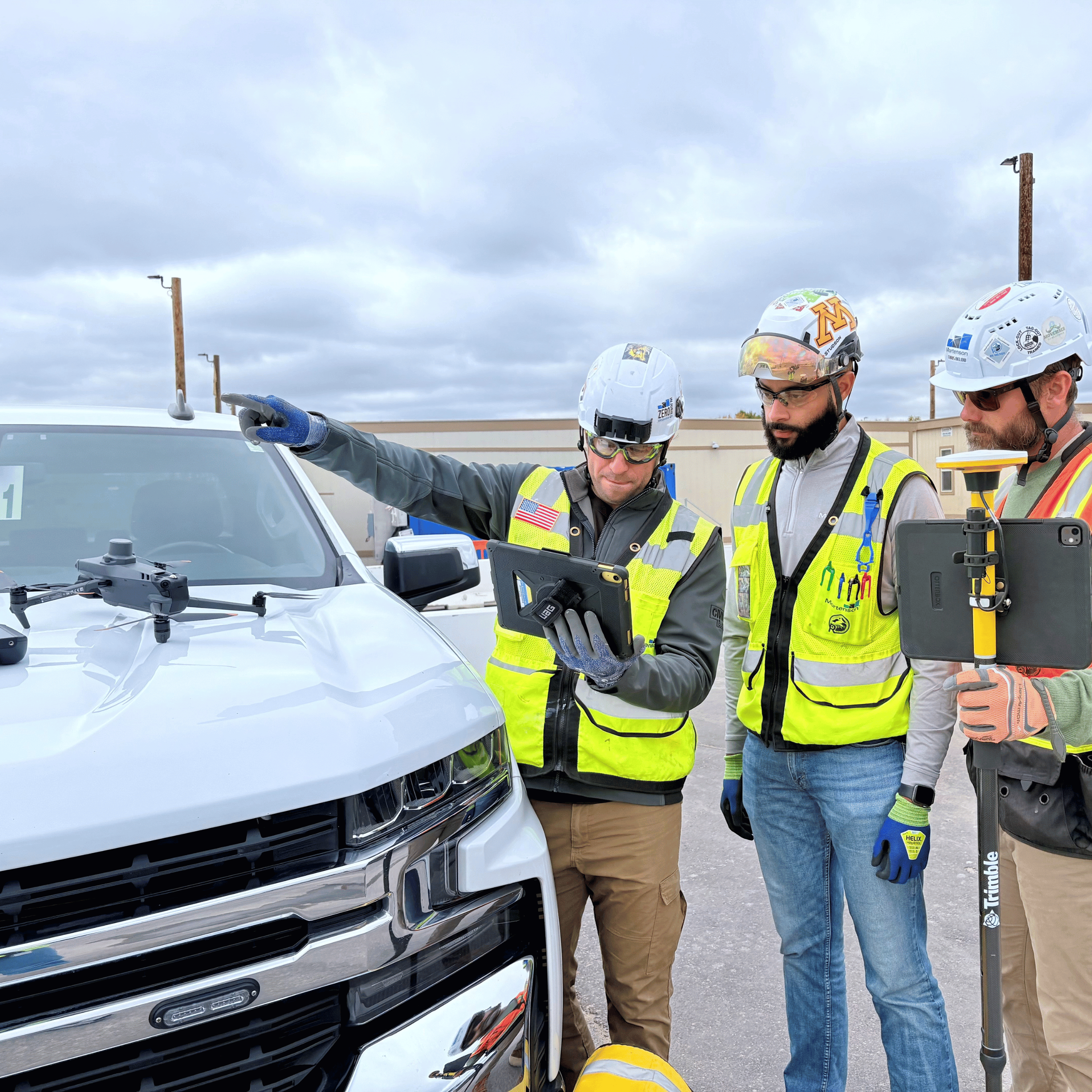 Mortenson Construction workers standing around a white truck