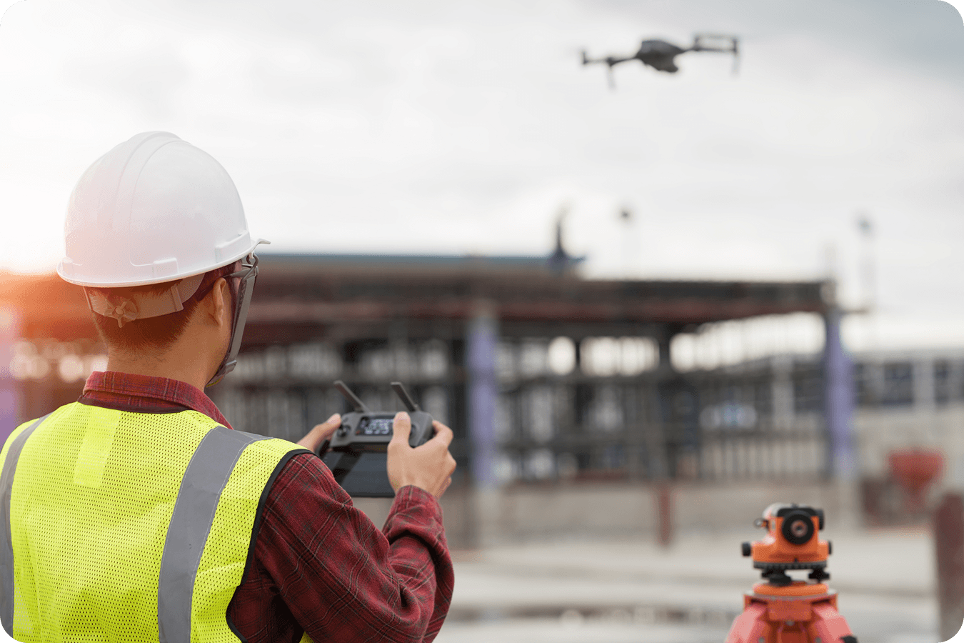Surveyor flying a drone in the field