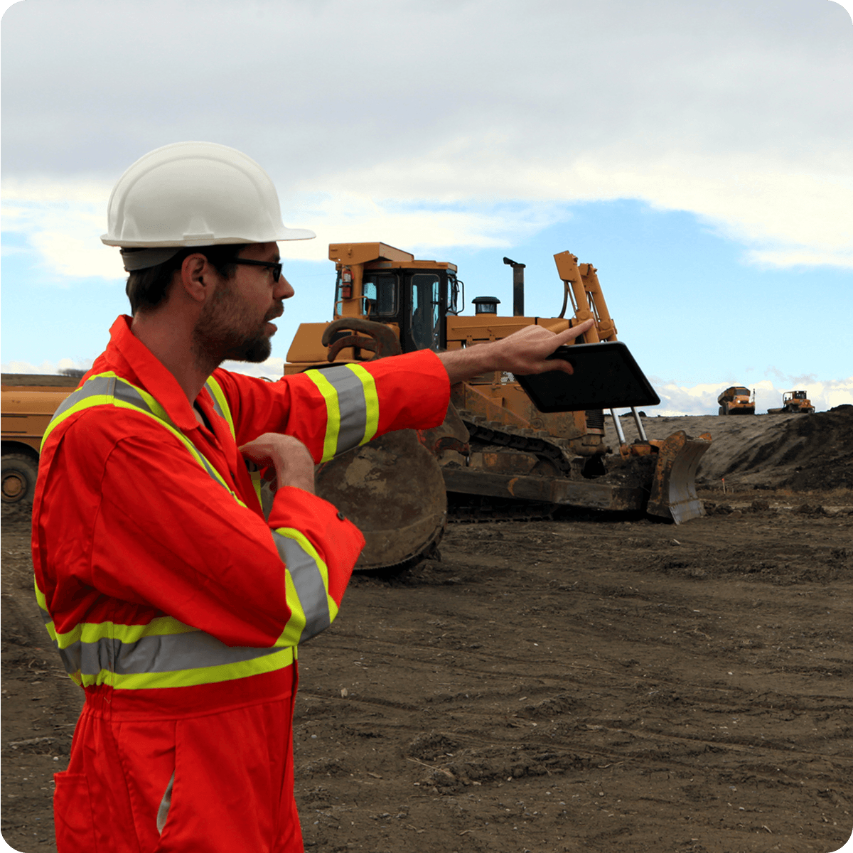 foreman working onsite in front of machines on a construction site