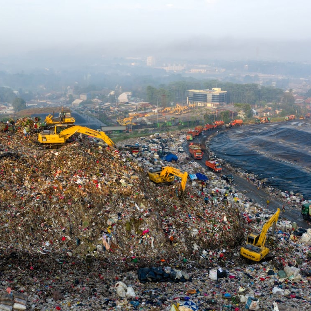 waste garbage truck dumping waste into a landfill