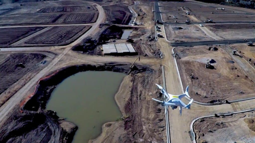 Drone flying over a new urban construction site.