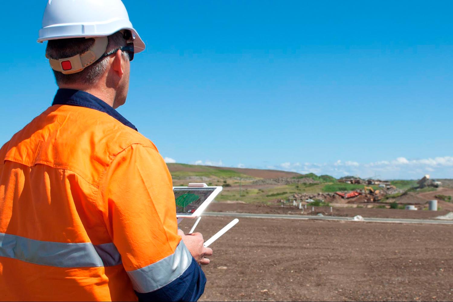 Drone pilot surveying on site.