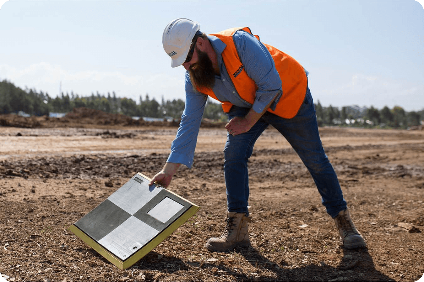 man laying down an aeropoint in a field