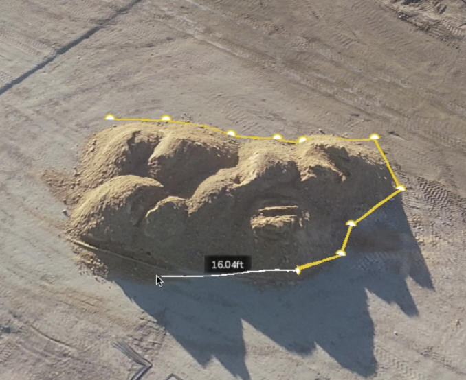 an active shot of taking a measurement of a stockpile