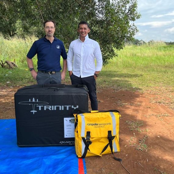 two men standing behind a Quantum trinity drone and Propeller AeroPoint set