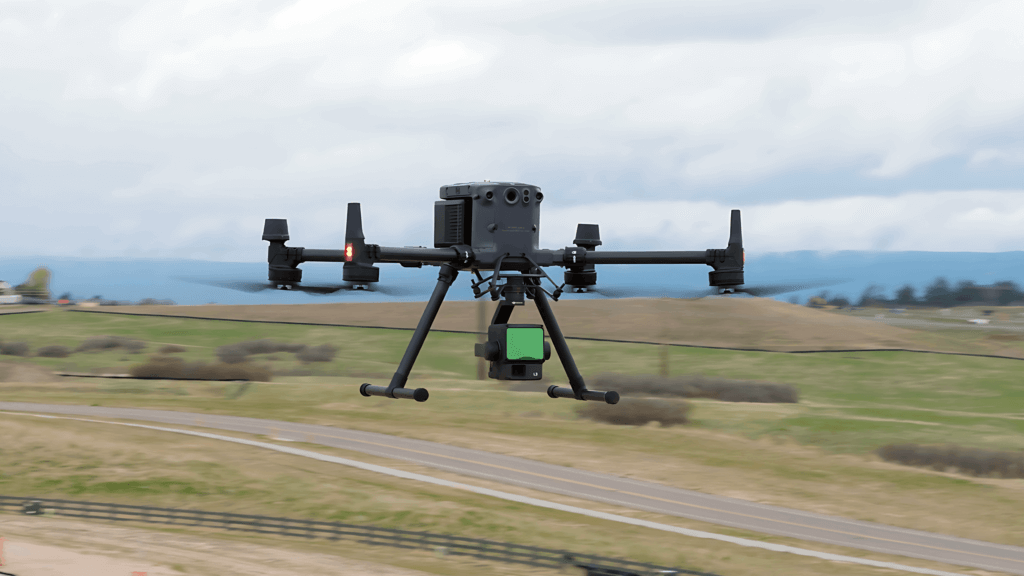 A close-up aerial shot of a flying drone with a burred background.