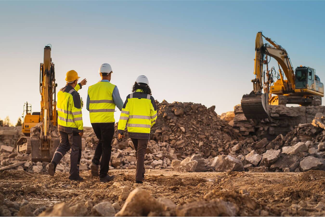 three construction workers inspecting site