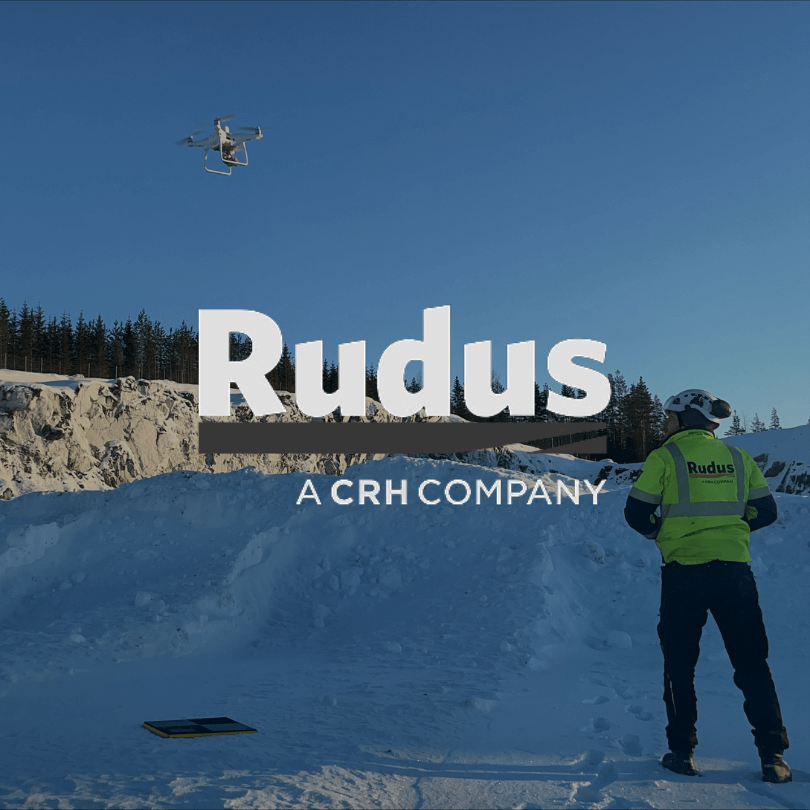 Rudus a CHR company logo in front of a construction site with snow